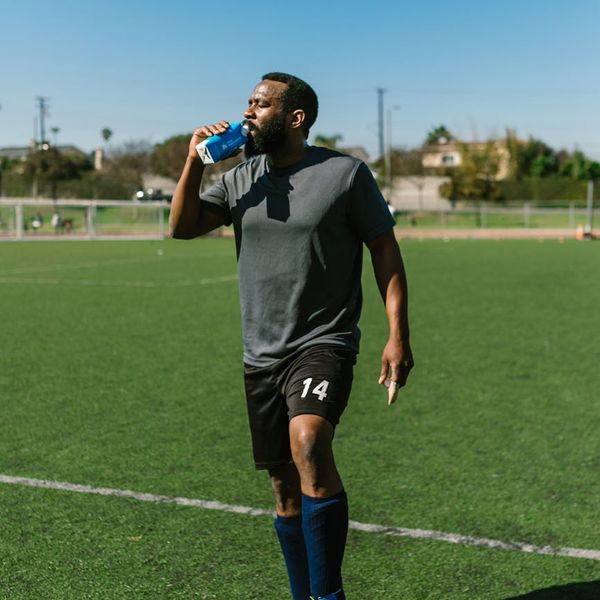 Person stretching outdoors during a beautiful sunrise.